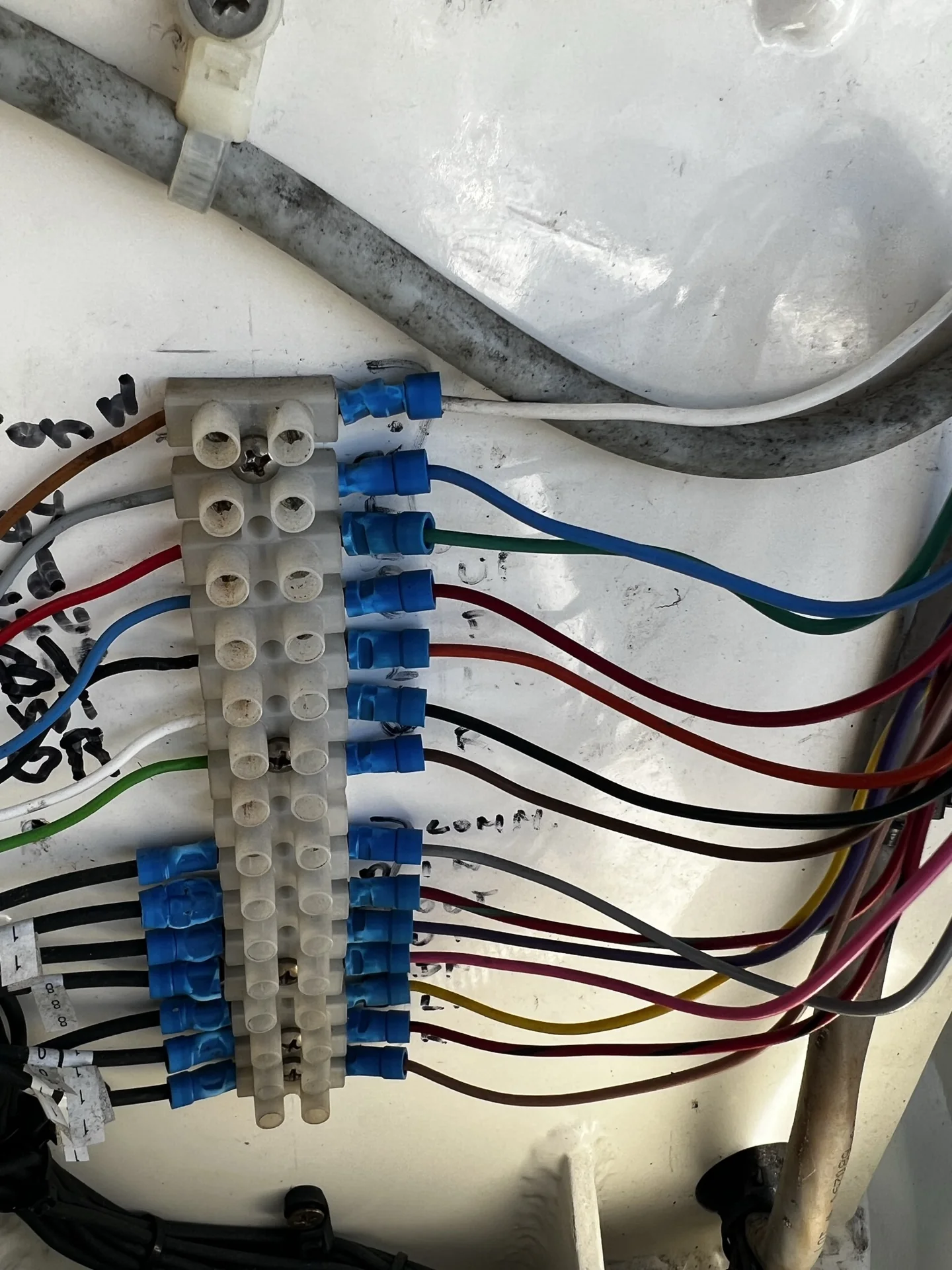 Marine electrical terminal block with labeled colored conductors and insulated connectors