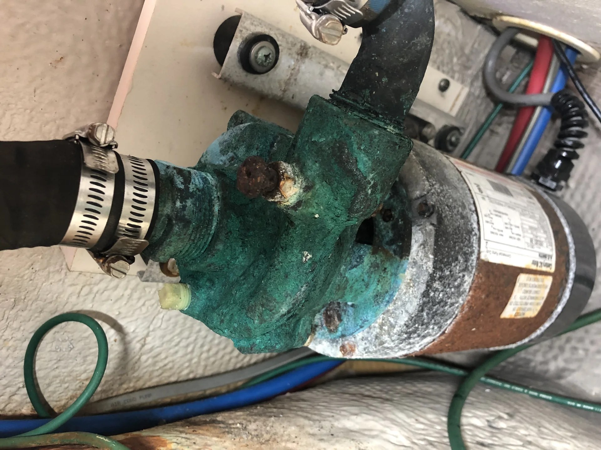Removed marine pump and motor assembly with substantial exterior corrosion