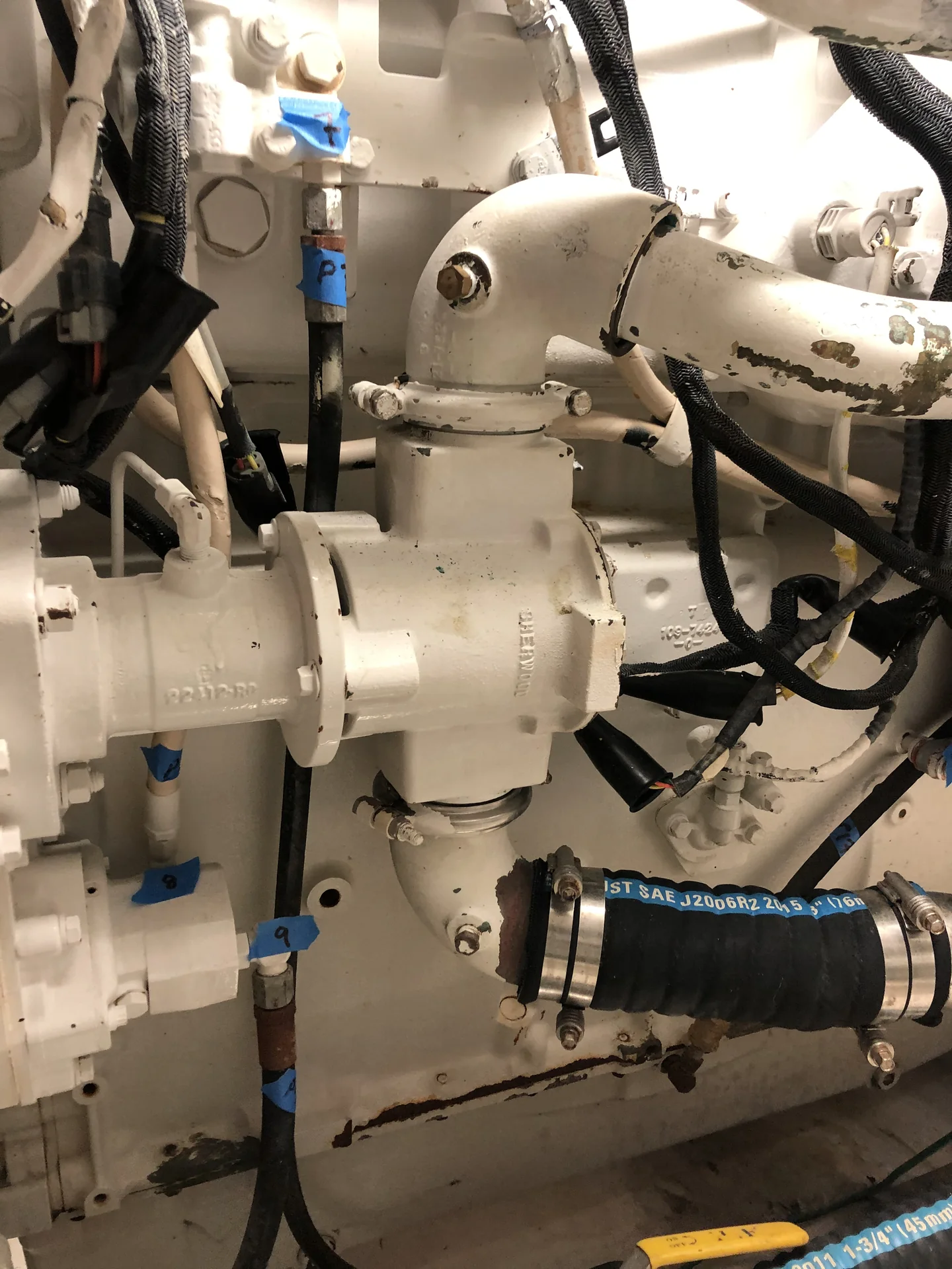 Marine engine raw-water pump with connected cooling-system plumbing