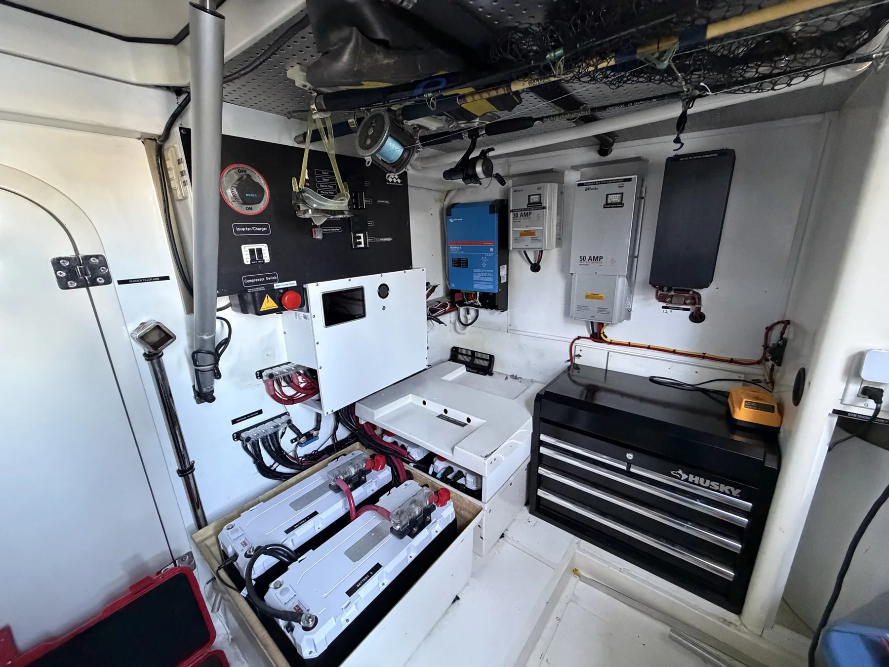 Marine electrical compartment with battery bank, inverter, chargers, and distribution equipment