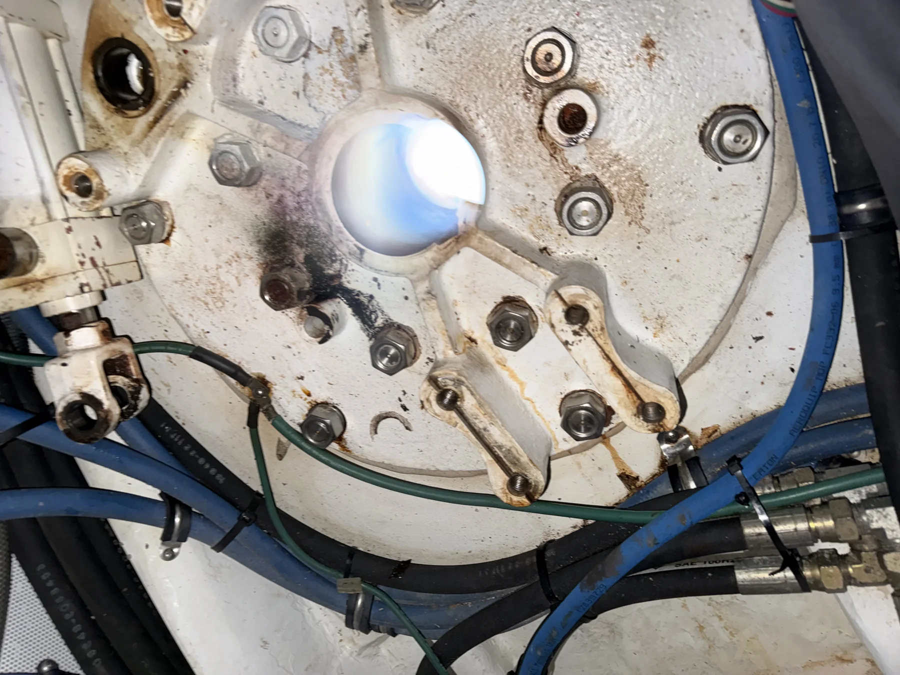 Disassembled marine stabilizer actuator with shaft housing, hydraulic linkages, and hoses