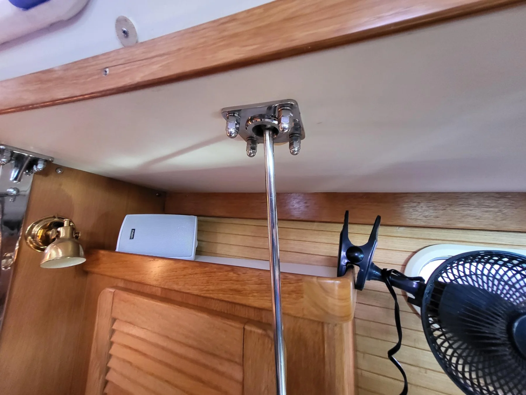 Stainless steel chainplate tie rod and backing plate mounted below a sailboat deck