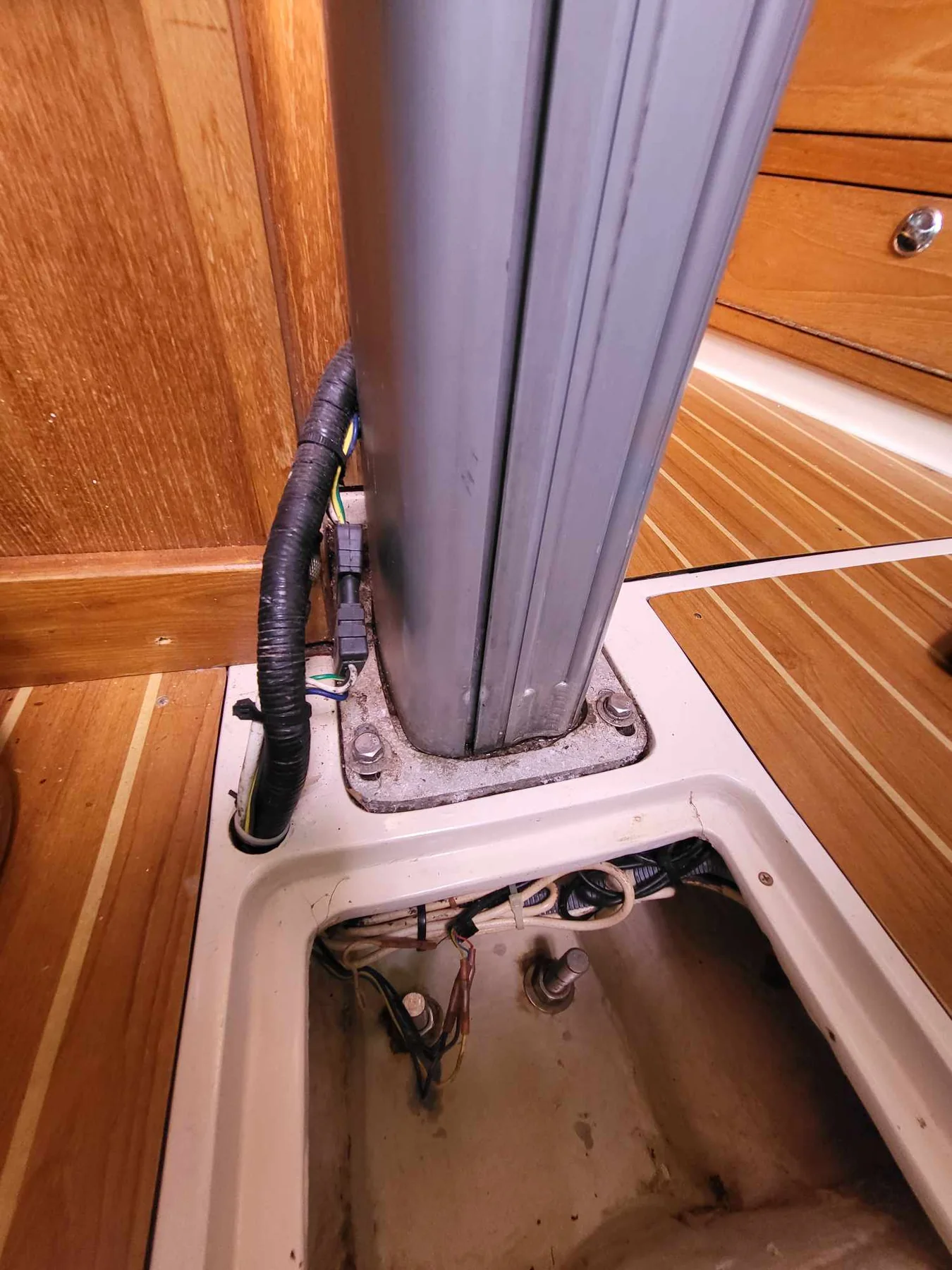 Keel-stepped aluminum sailboat mast base passing through the cabin sole