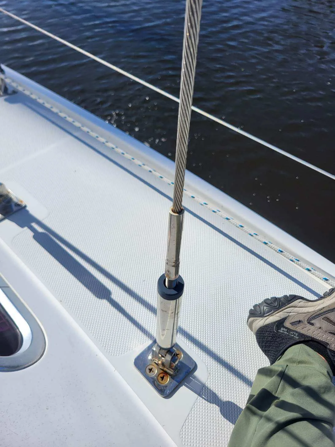 Stainless steel turnbuckle connecting wire shroud to a sailboat deck chainplate